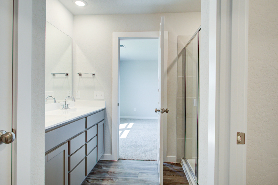 A bathroom with a glass door.