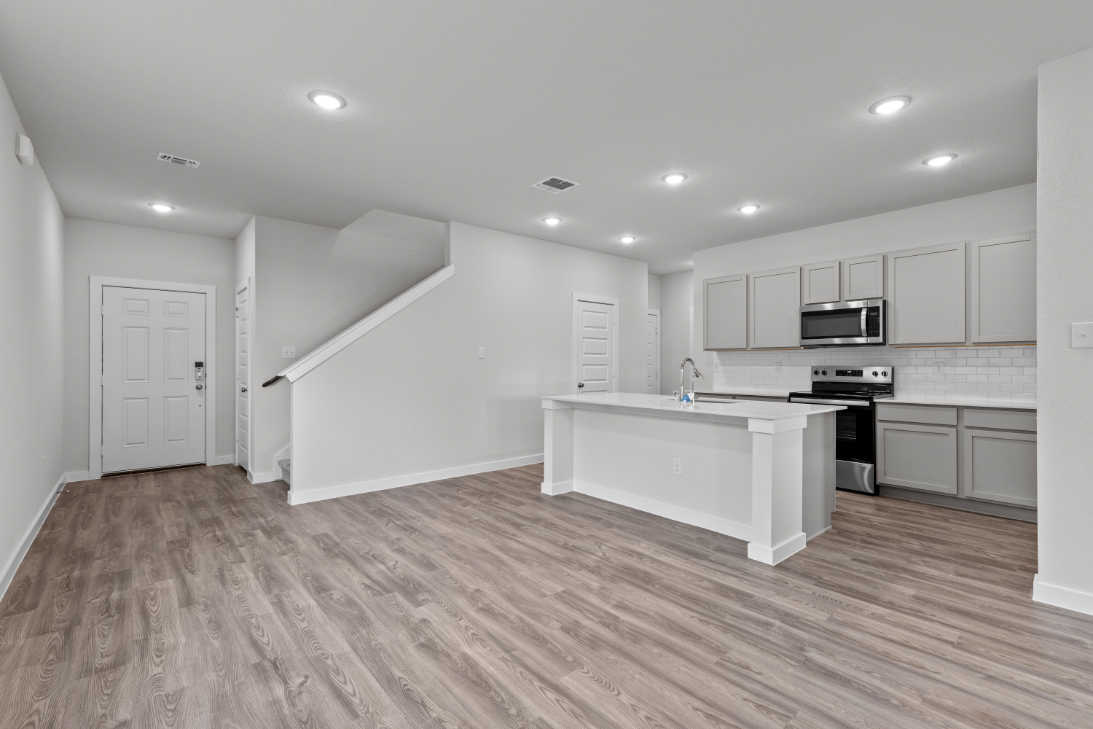 A large kitchen with white cabinets.