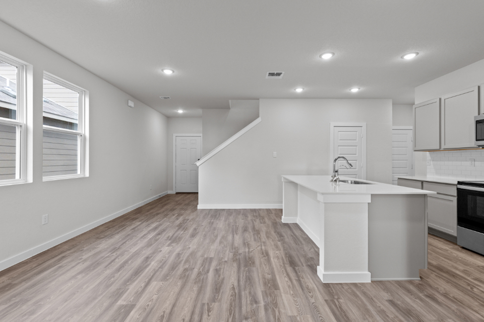 A kitchen with white cabinets.