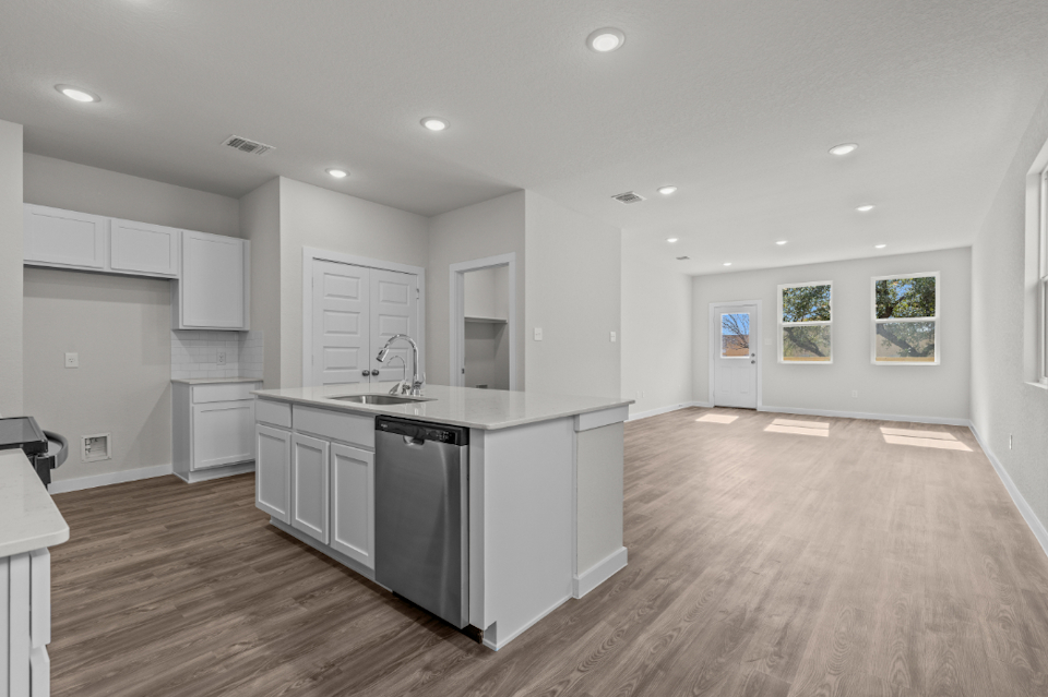 A kitchen with white cabinets.