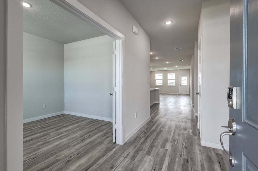 A hallway with white doors.