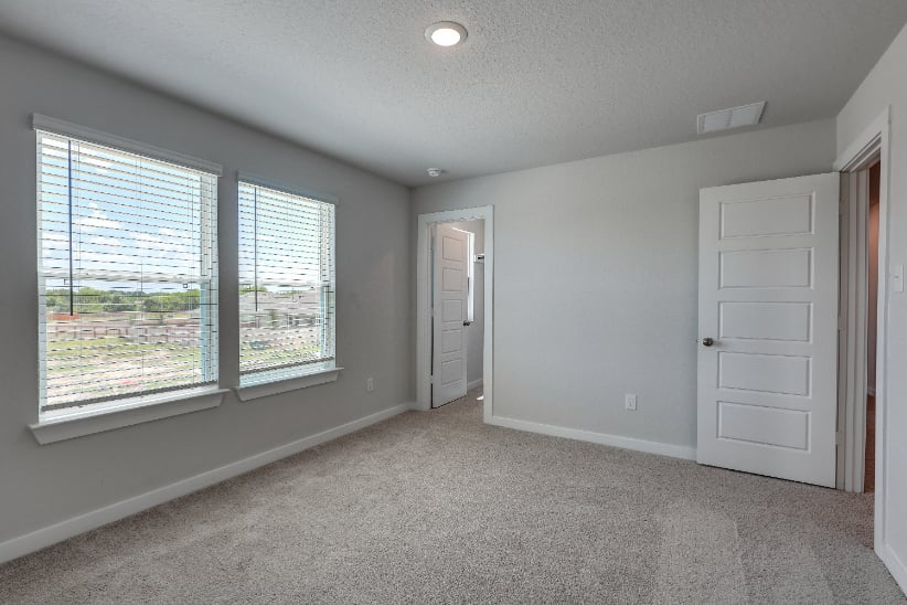 A room with a window and a door.