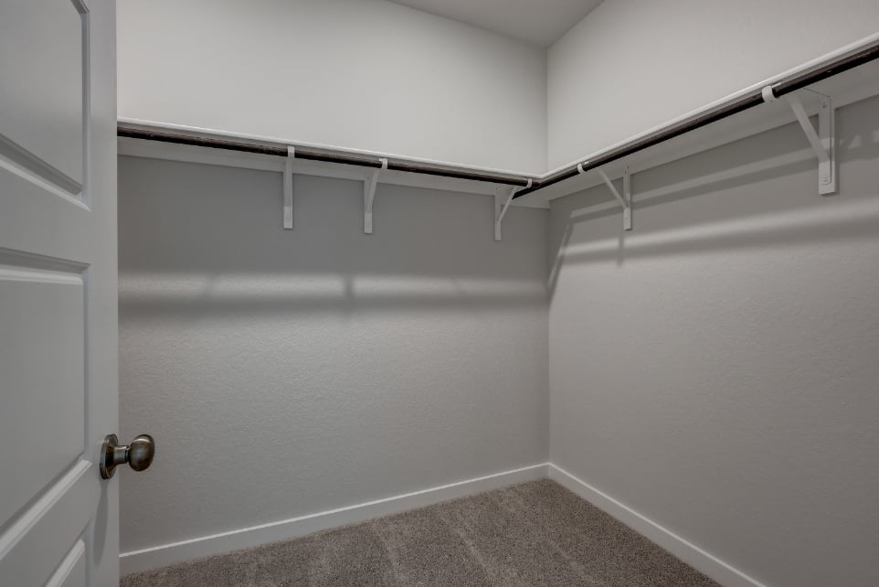 A white wall with a metal railing.