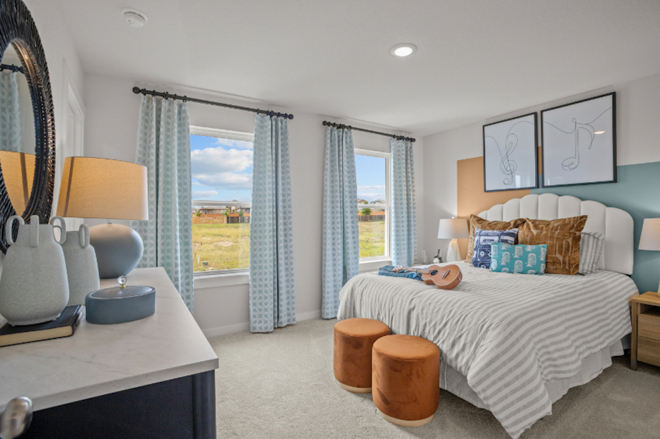 A bedroom with a bed and a desk.