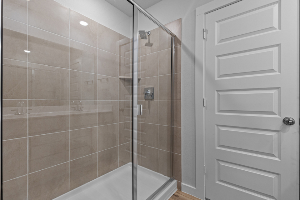 A shower with a glass door.