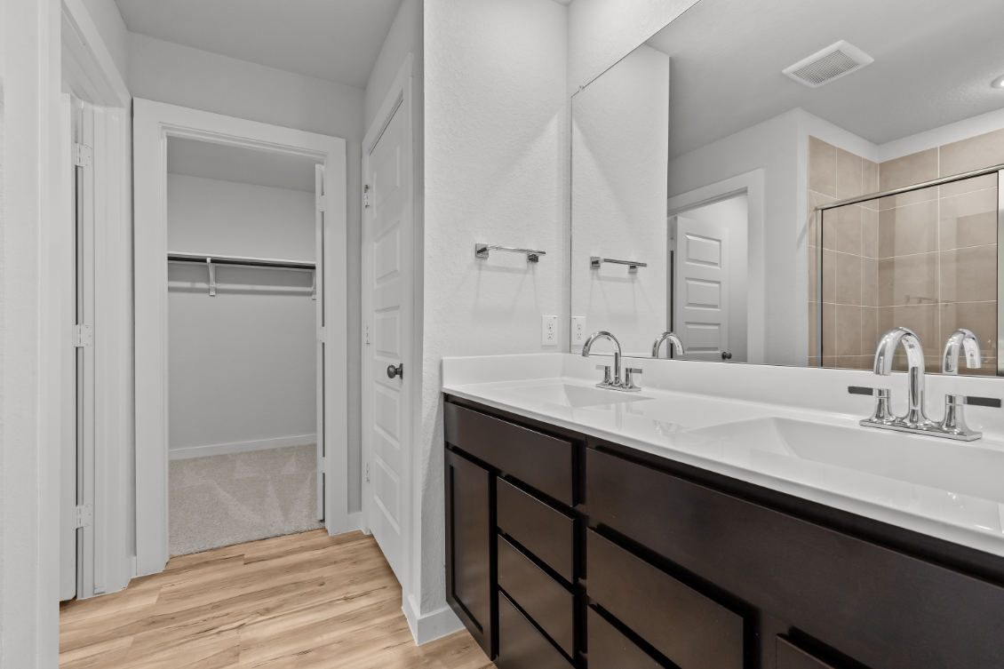 A bathroom with a large mirror.