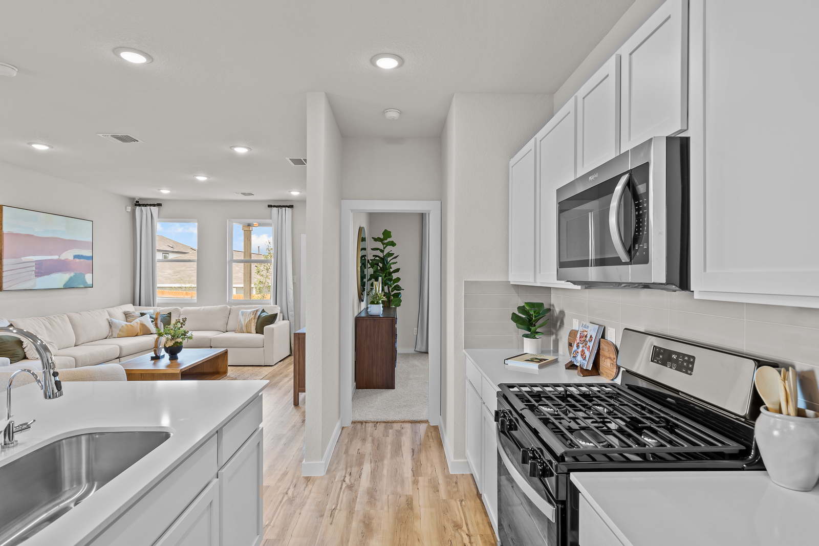 A kitchen with white cabinets.