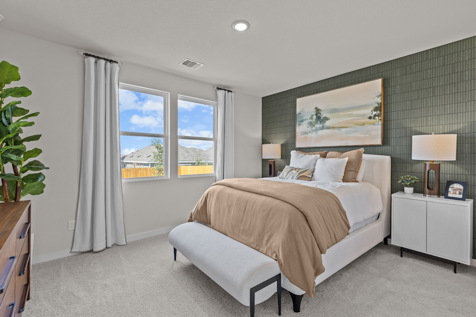 A bedroom with a large window.