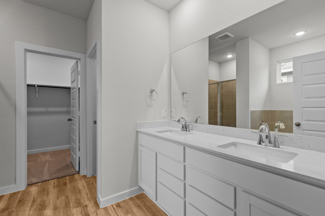 A bathroom with a large mirror.