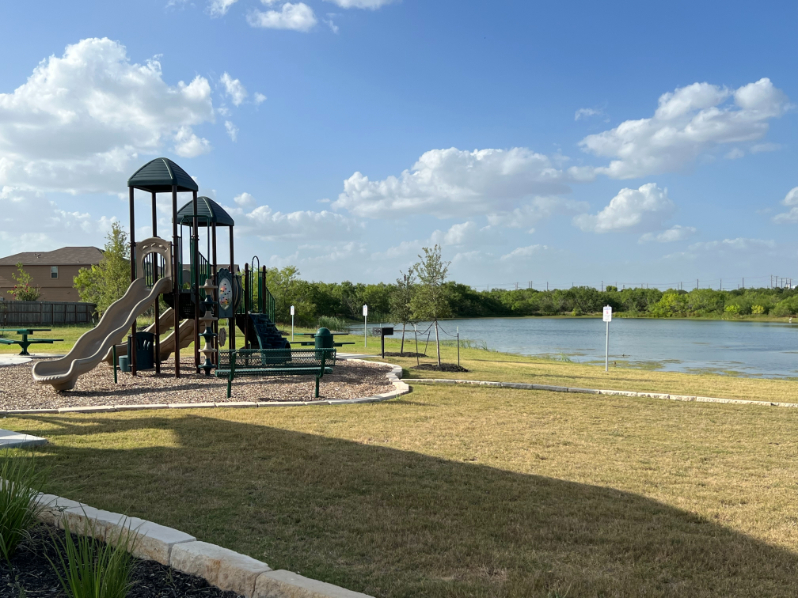 A playground by a lake.