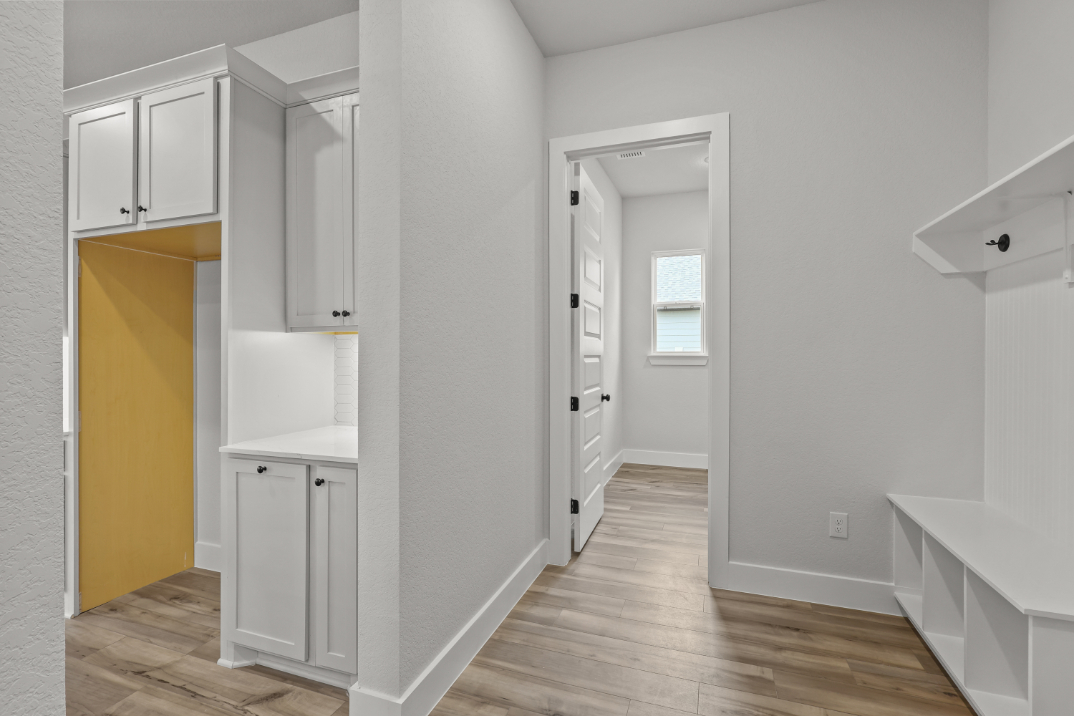 A white room with white cabinets.