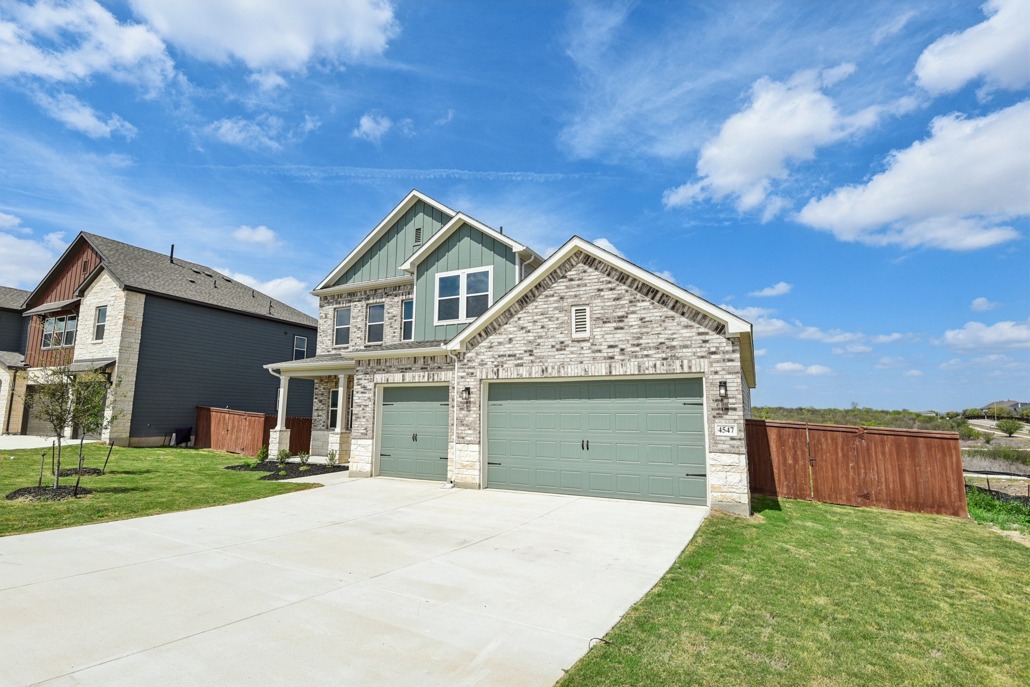 A house with garages and grass.
