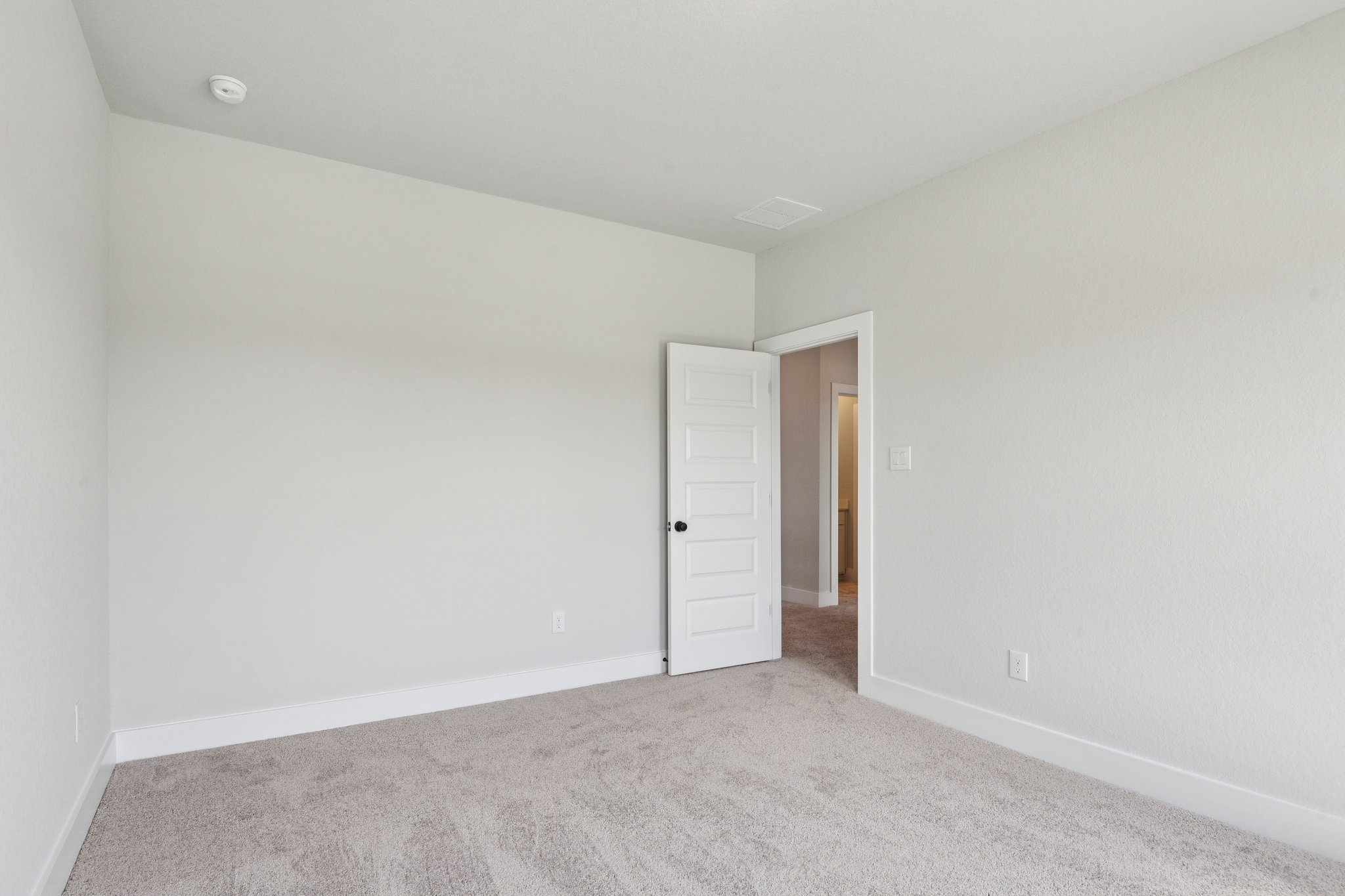 A hallway with white walls.