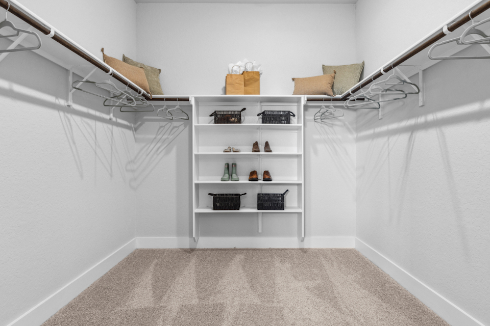 A white room with shelves and a white wall.