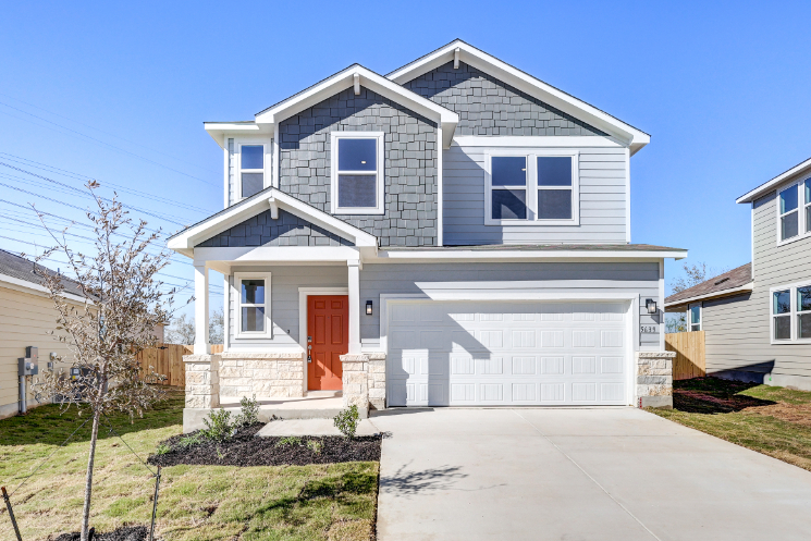 A white house with a garage.