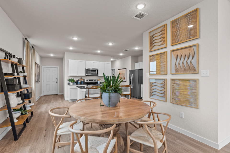 A kitchen with a dining table.