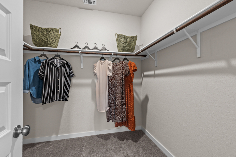 A row of towels on a rack in a bathroom.