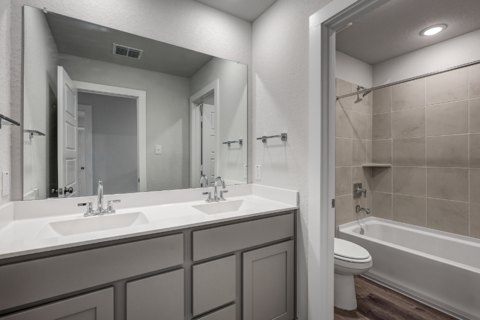 A bathroom with a tub sink and toilet.