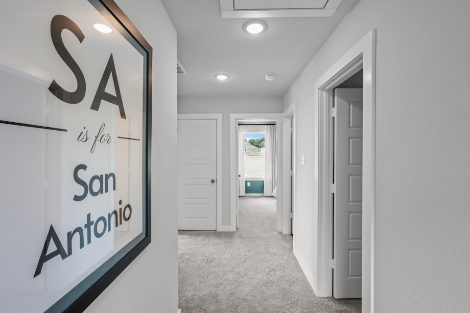 A hallway with white doors.
