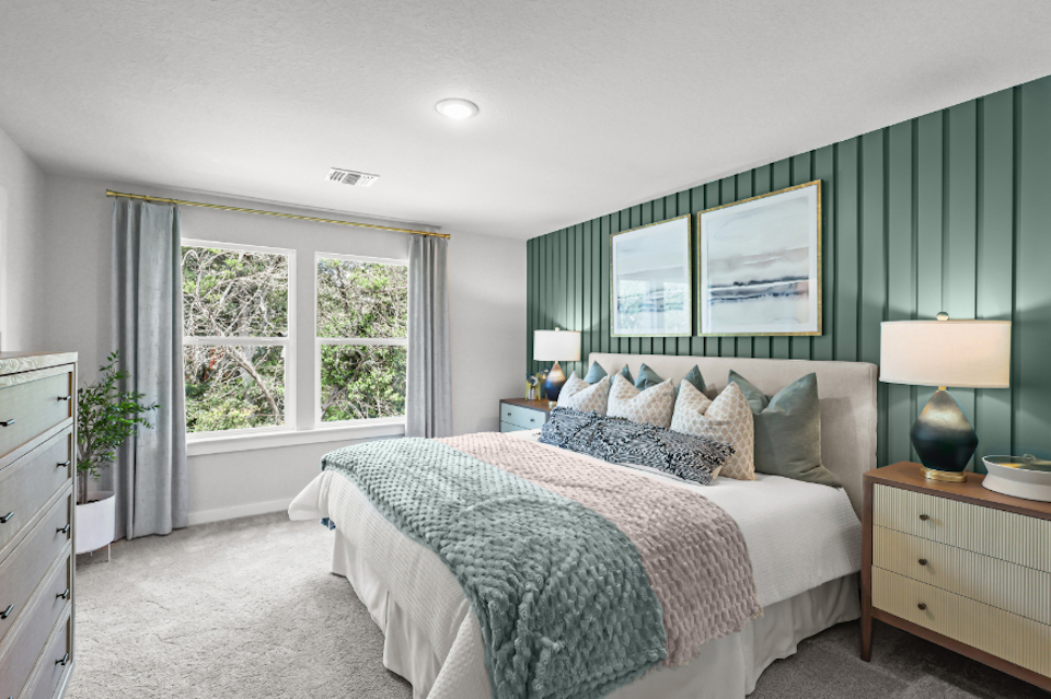 A bedroom with a bed and a window.