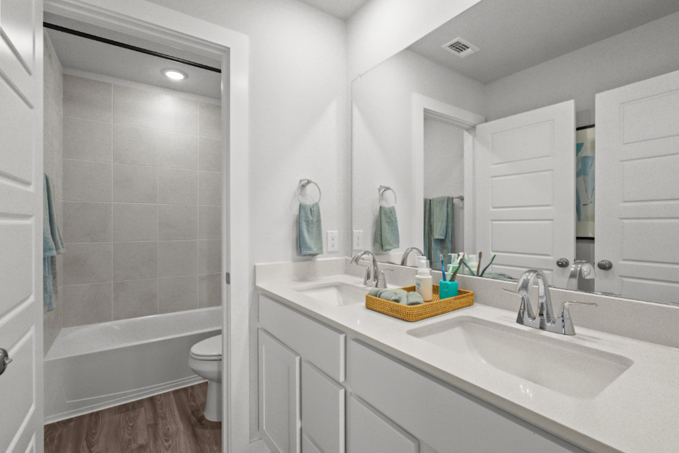 A bathroom with a tub sink and toilet.