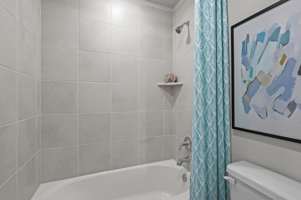 A bathroom with a bathtub and toilet.