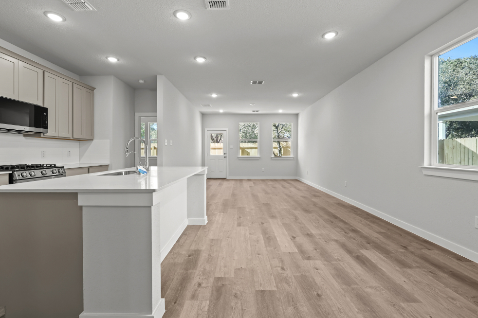 A kitchen with white cabinets.