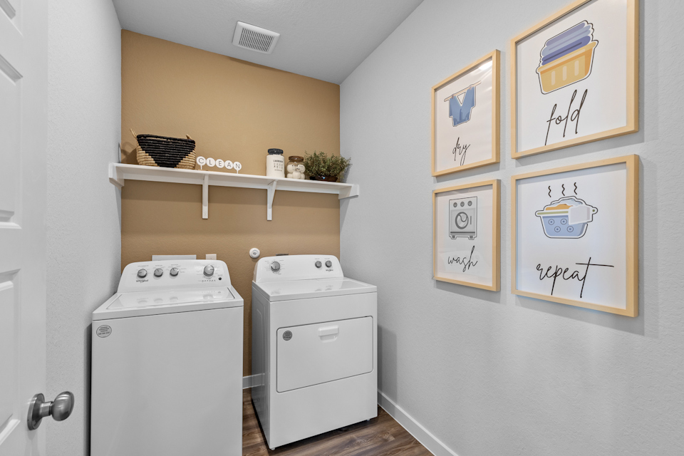 A laundry room with white walls.