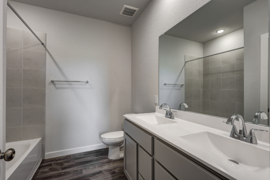 A bathroom with a tub sink and toilet.