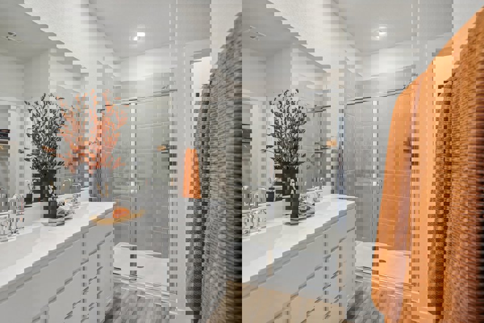 A bathroom with a shower and sink.