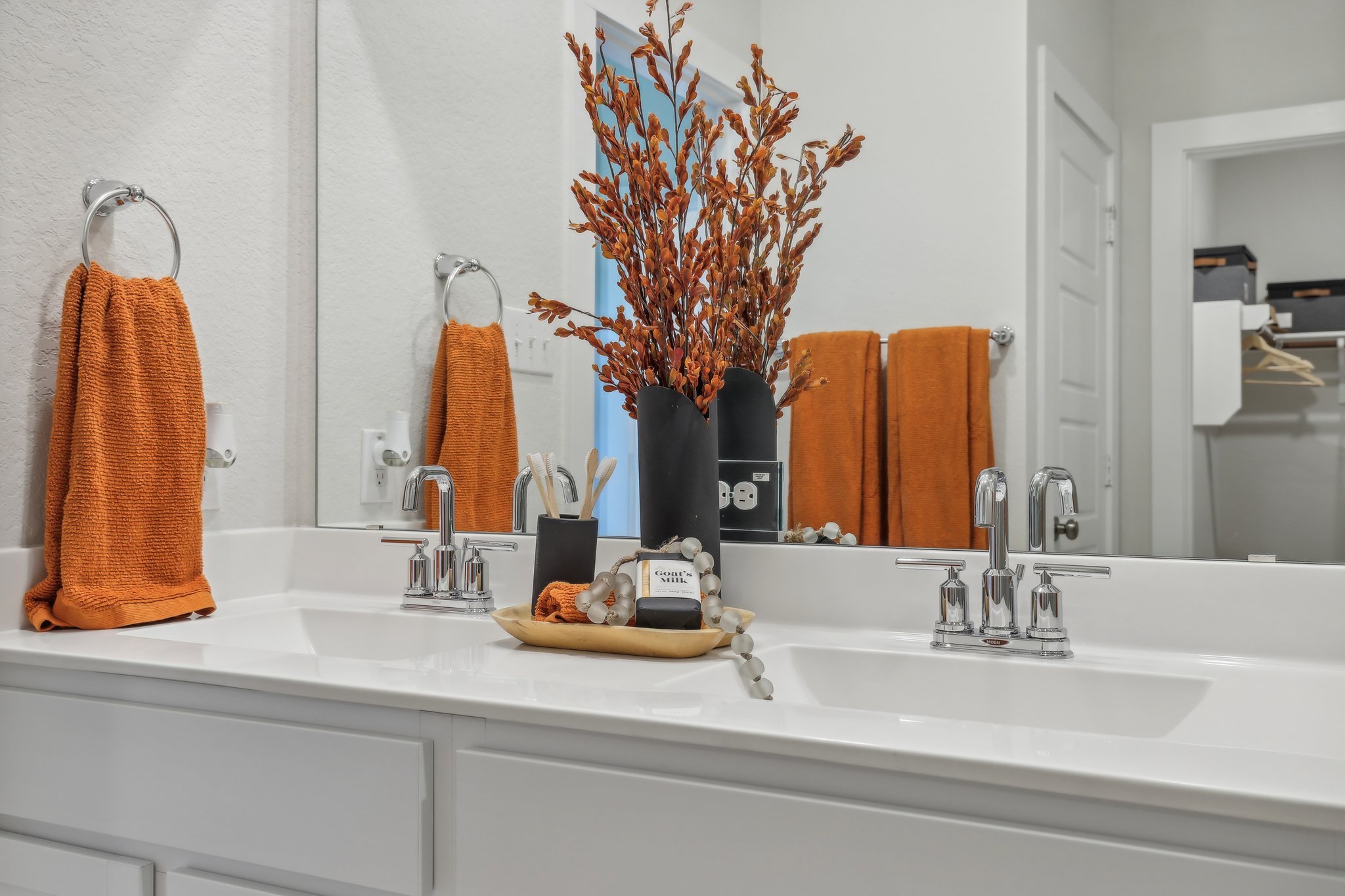 A bathroom with a vase of flowers.
