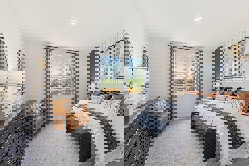 A bedroom with a bed and a desk.