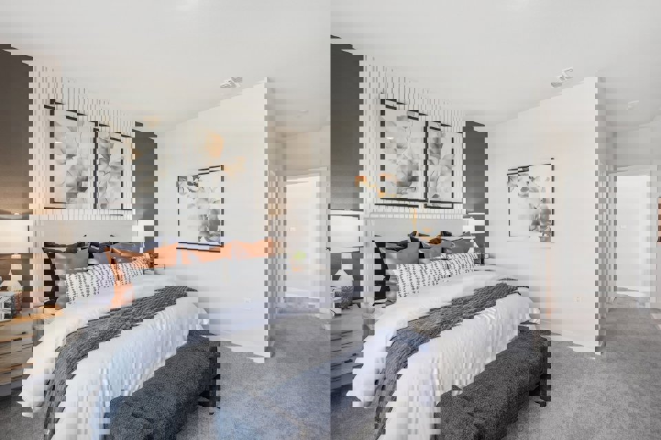 A bedroom with a bed and a bench.