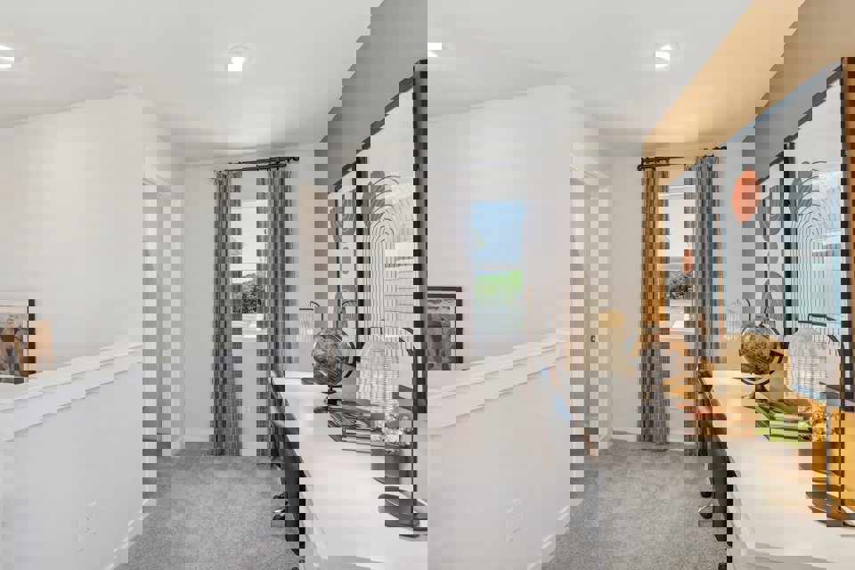 A room with a desk and a mirror.