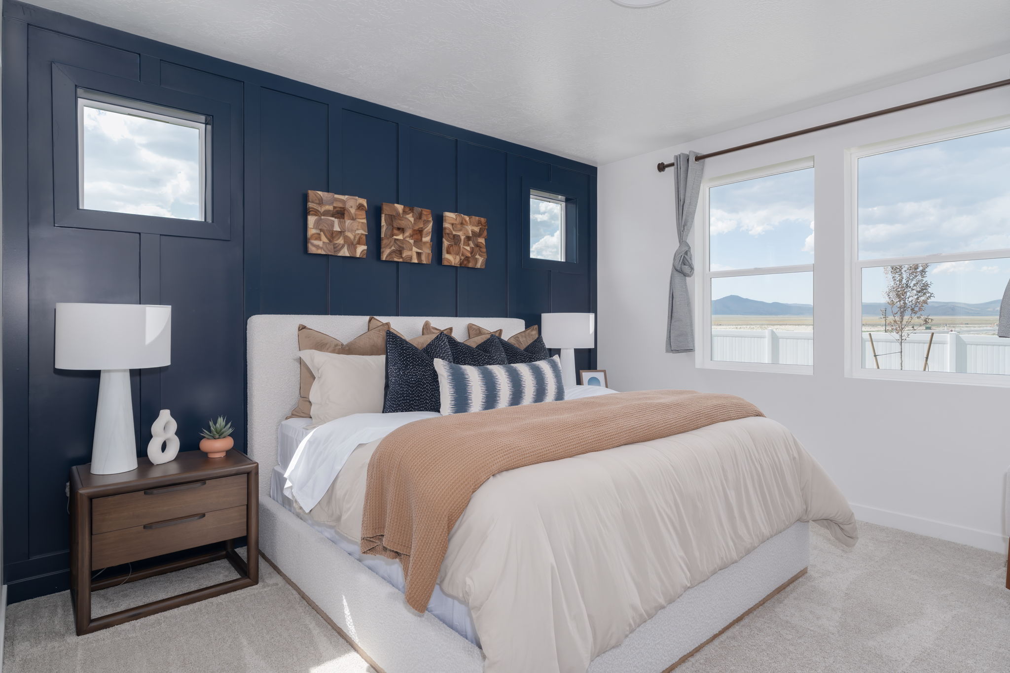 A bedroom with a bed and a window.