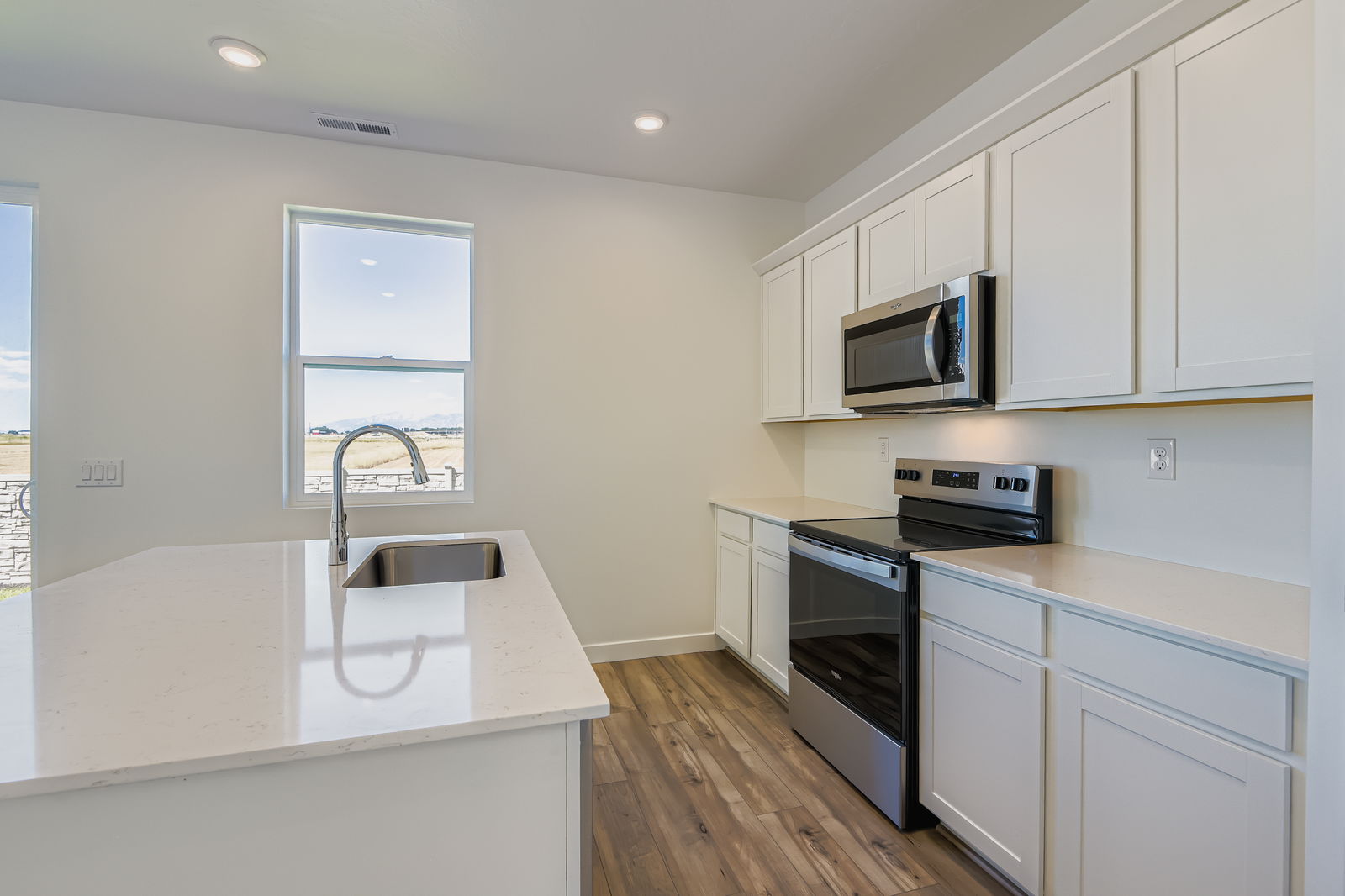 A kitchen with white cabinets.