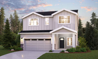 A house with a garage and trees around it.