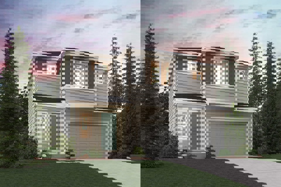 A house with a garage and trees.