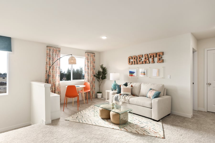 A living room with a couch and a rug.