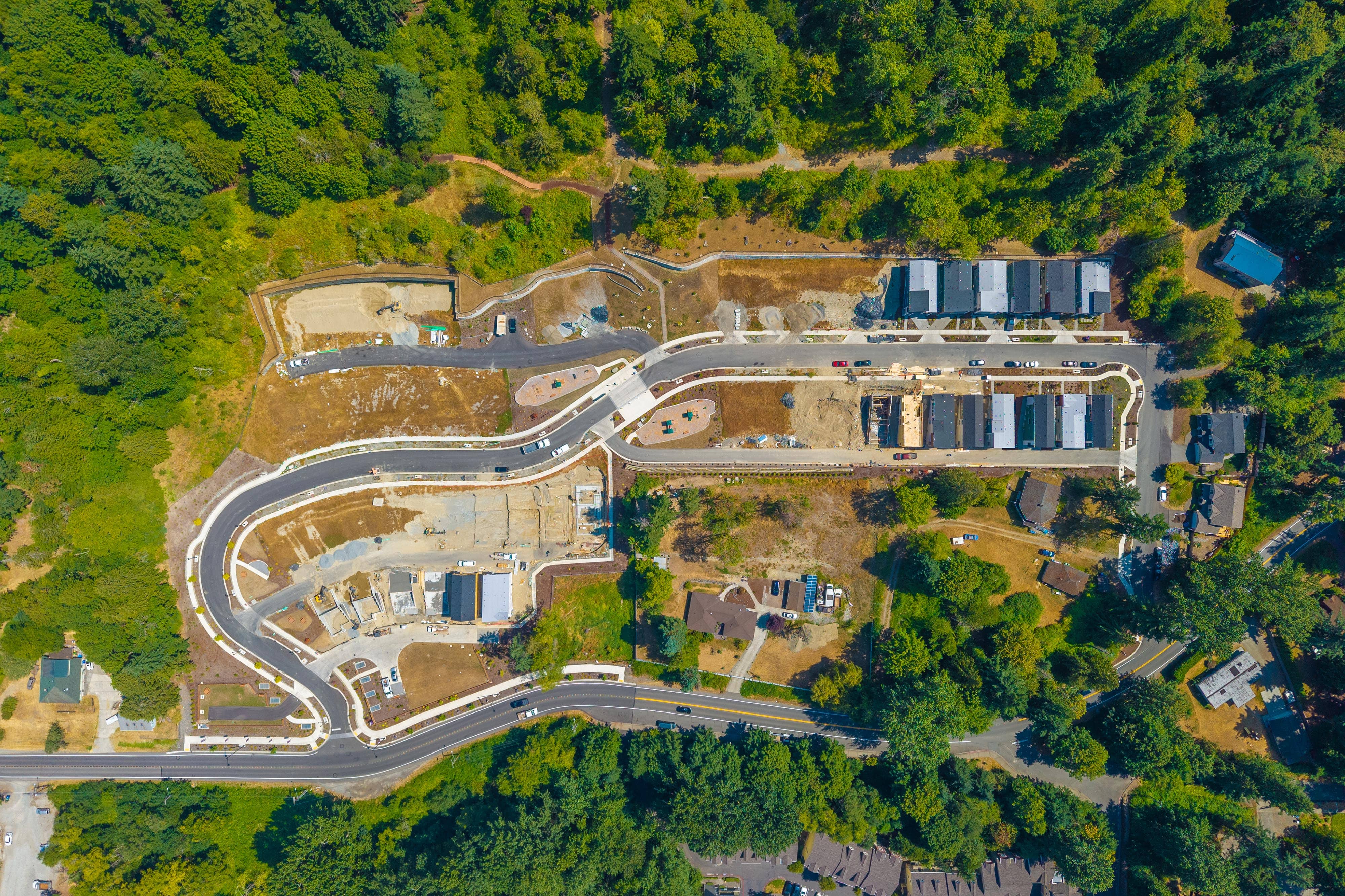 A large building with a bridge over it surrounded by trees.