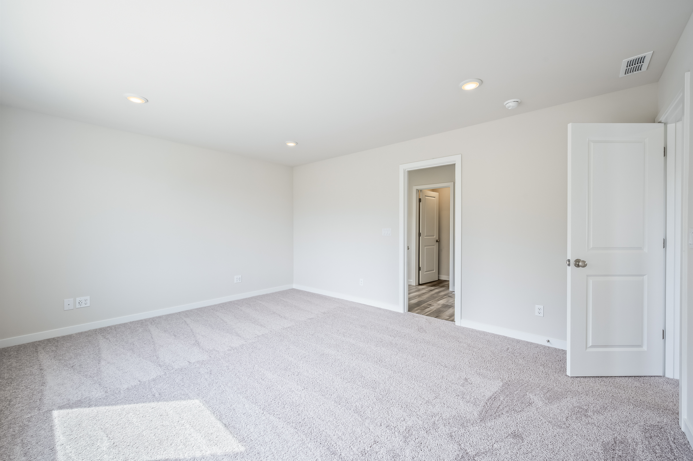 A hallway with white walls.