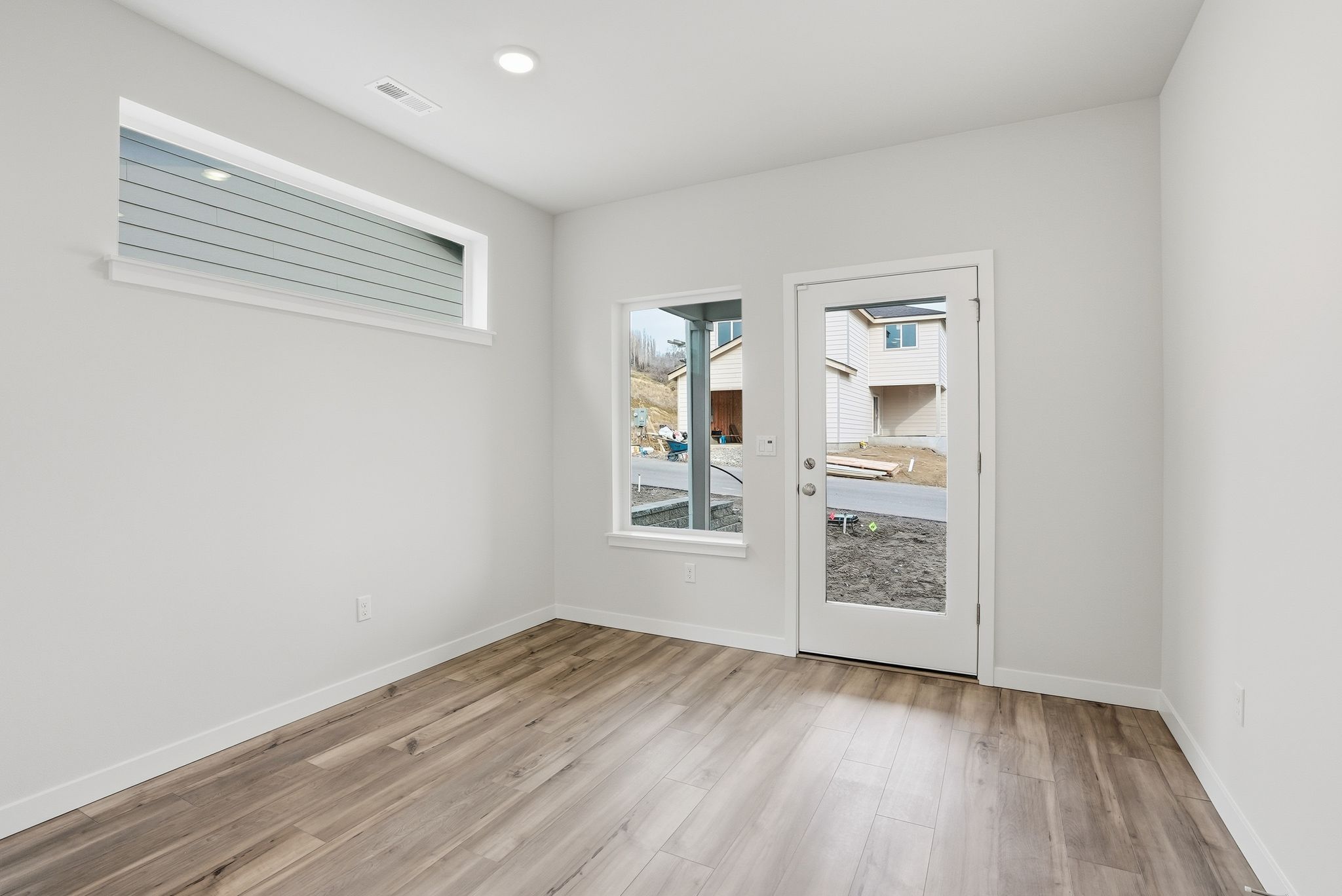 A room with a wood floor and a window.