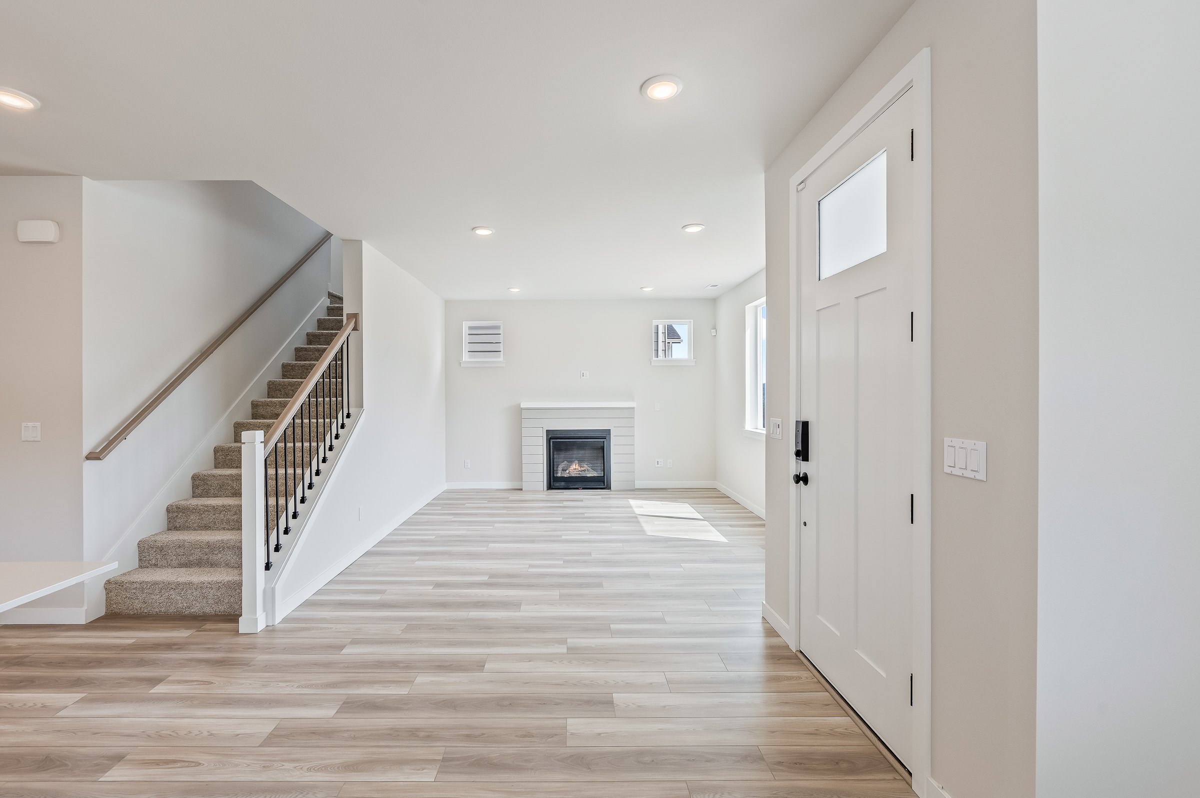 A large white room with a fireplace.