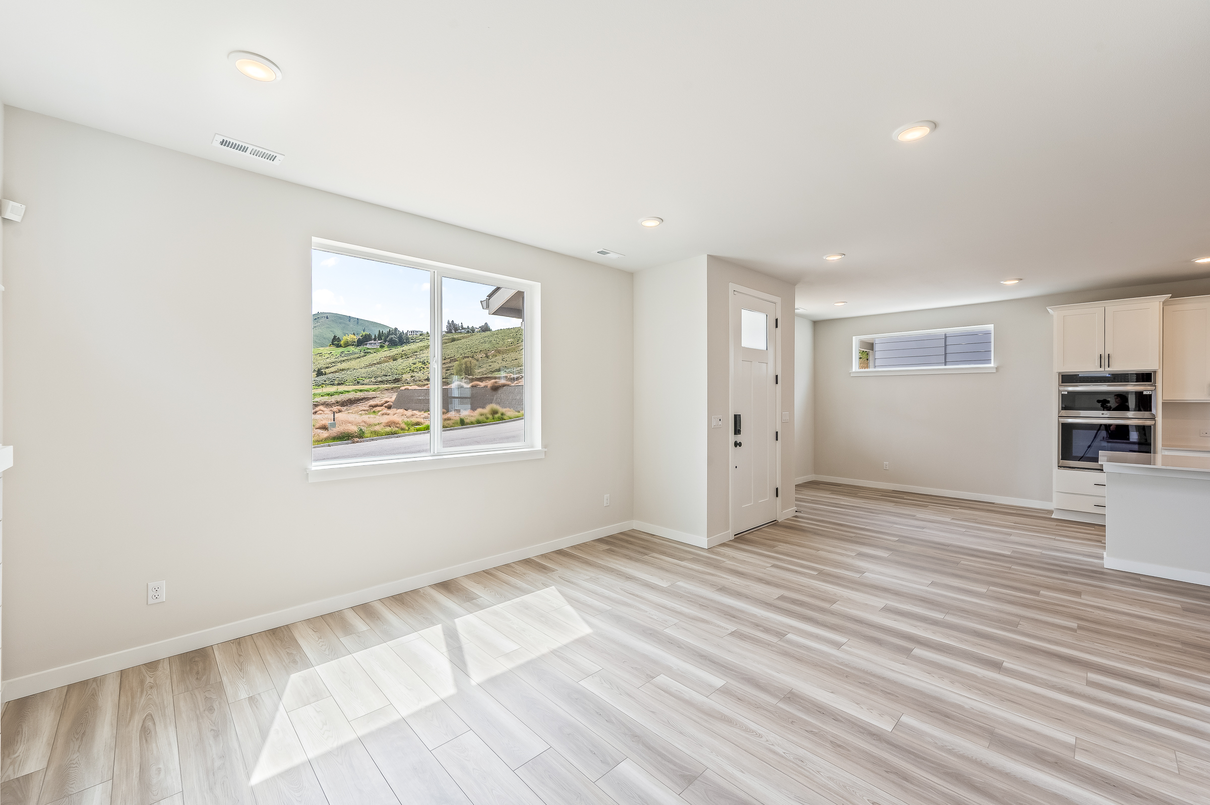 A room with a wood floor and a window.