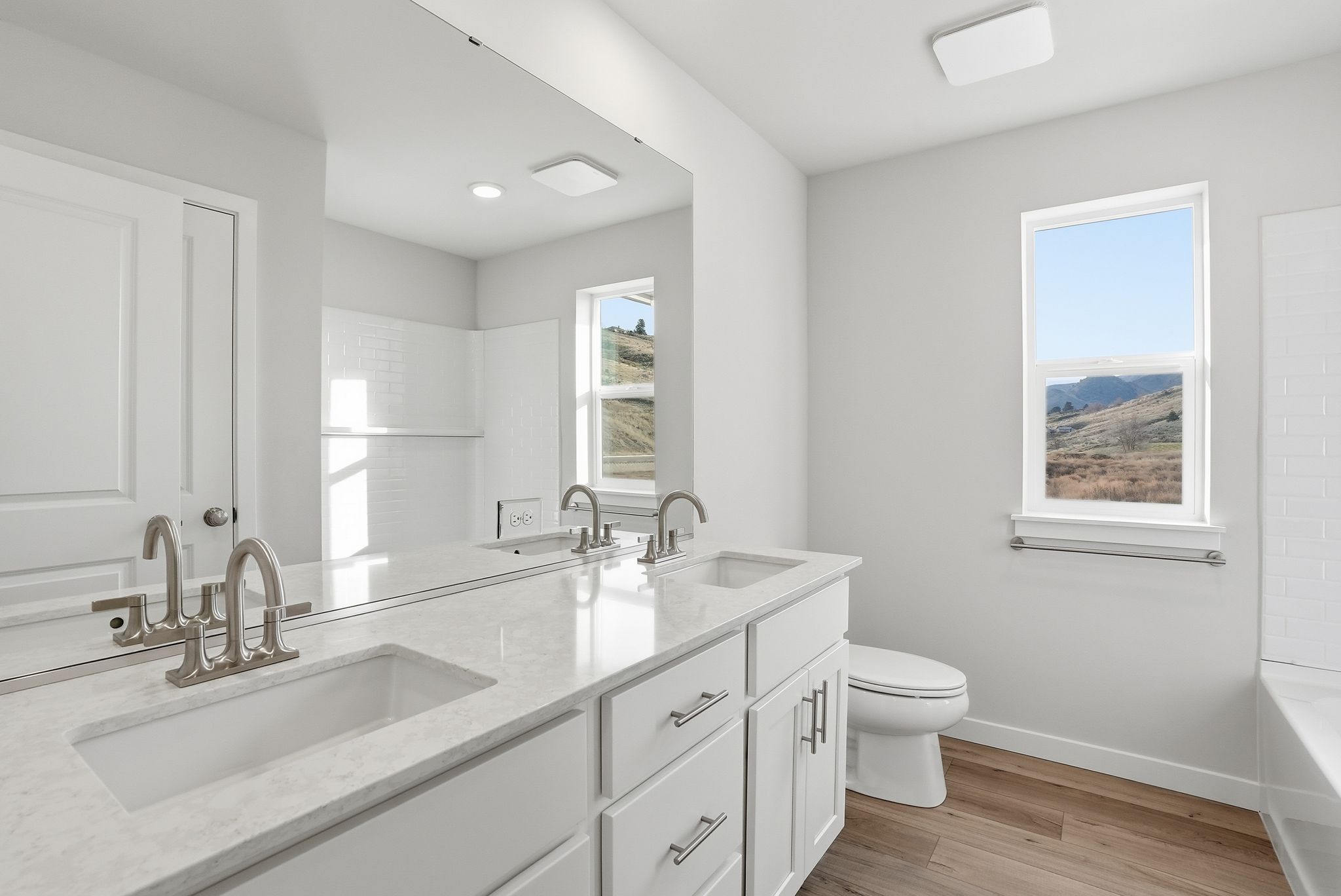 A bathroom with a large mirror.
