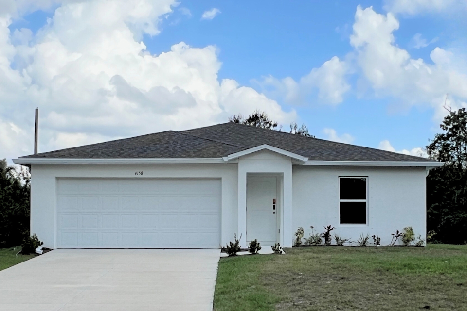 A white house with a garage.
