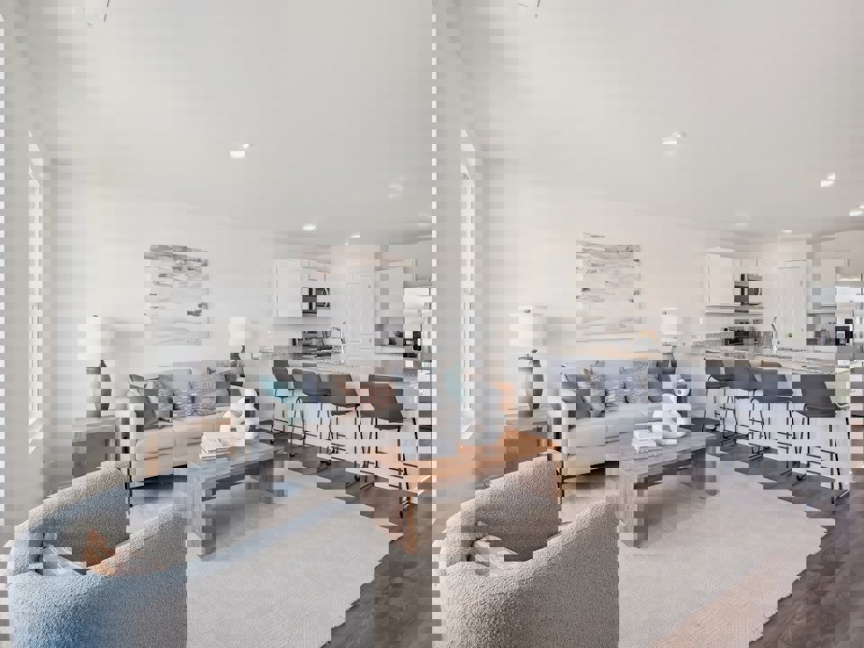 A living room with a couch and chairs.