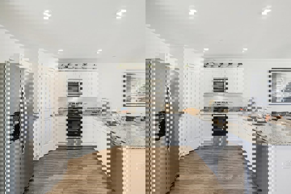 A kitchen with white cabinets.