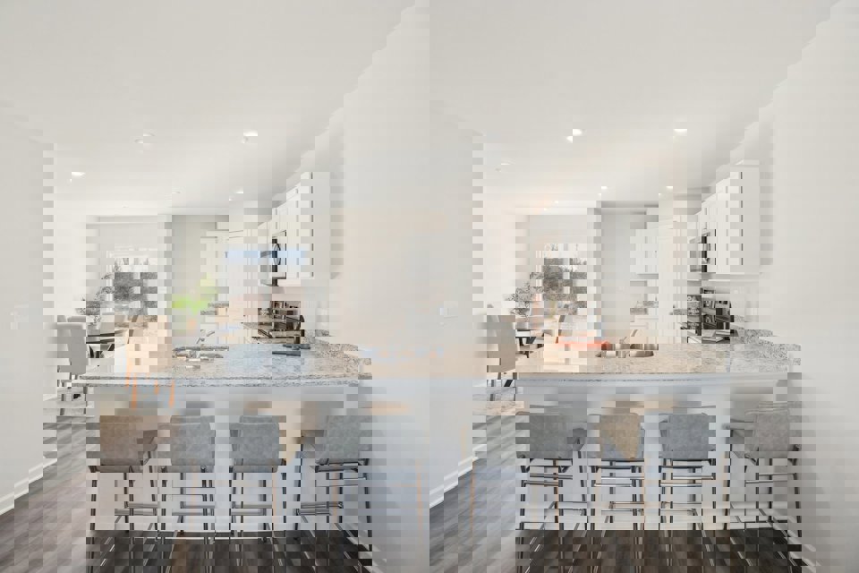 A kitchen with a marble island.