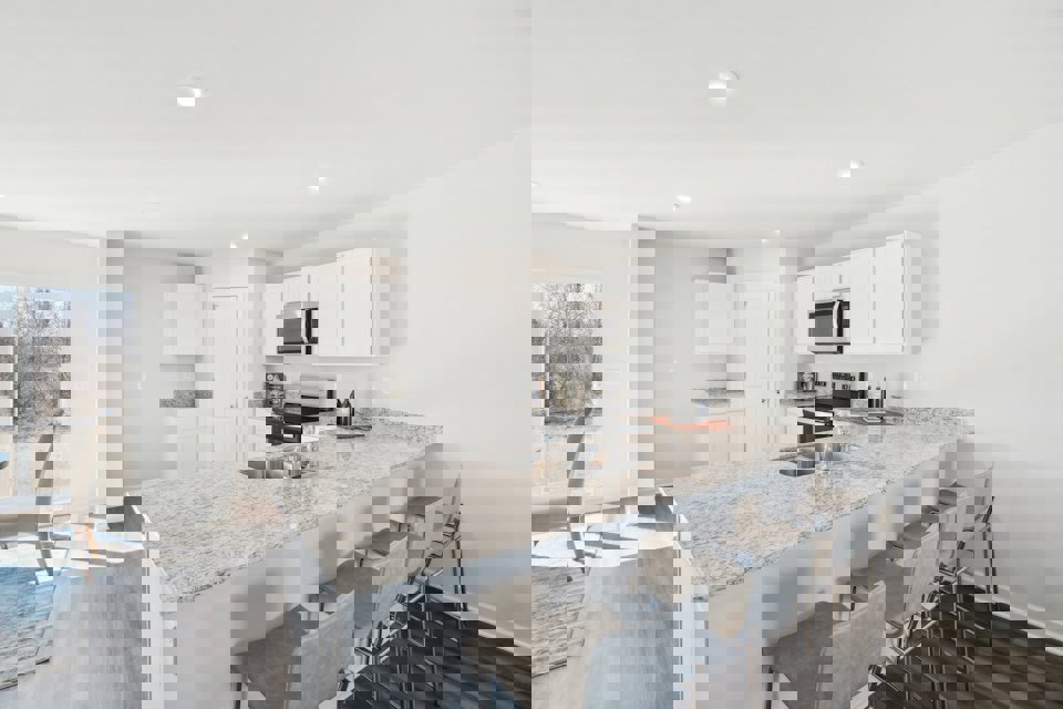 A kitchen with a marble island.